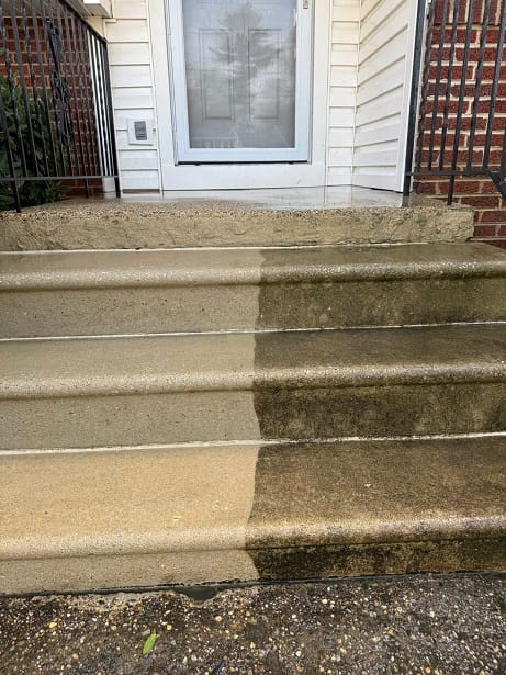 Concrete steps washed halfway: the left side is clean and the right side still has dark algae staining