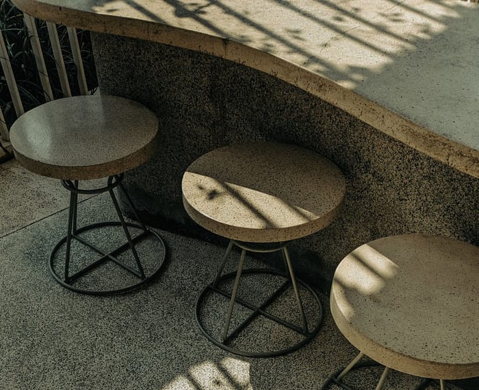 Round stone patio seating on a finished concrete surface